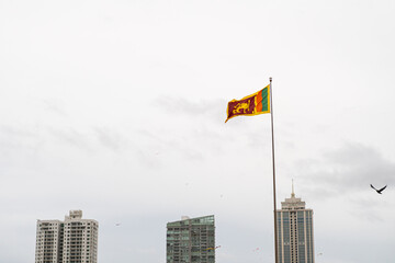 Sri Lanka flag against the sky and skyscrapers. © insomniafoto