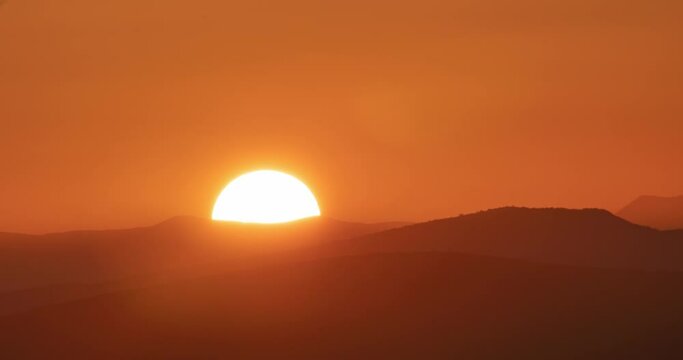 Big sun close-up timelapse rising at mountain.