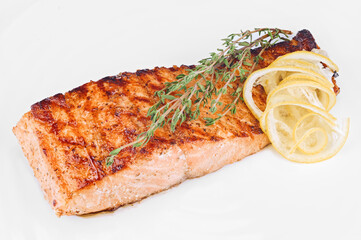 Organic salmon red fish fillet grilled with spices, lemon slices and rosemary
