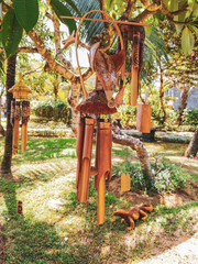 Fototapeta na wymiar Windchime with green garden, Tropical trees, Summer resort, The sound of the wind, Balinese handmade, Summer garden