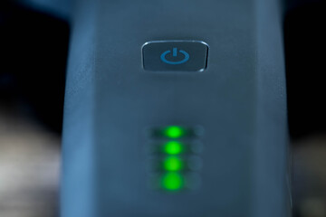 On off switch on electrical device , blinking gren leds ,close up macro shot.
