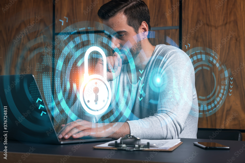 Poster a serious caucasian programmer in casual wears, using laptop to develop a new security system to pro