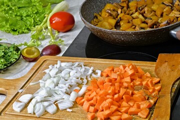 Cooking vegetables and champignons with sauce in a pan
