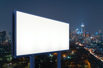 Fototapeta premium Blank white road billboard with Bangkok cityscape background at night time. Street advertising poster, mock up, 3D rendering. Side view. The concept of marketing communication to sell idea.