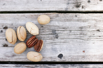 Pecan Nuts on wooden background, top view with copyspace. Close up veiw of nuts.