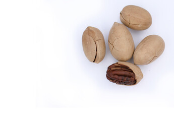 Pecan Nuts on white background, top view with copyspace. Close up veiw of nuts.