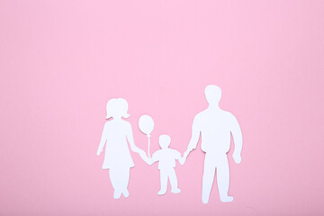 Family figures on pink background