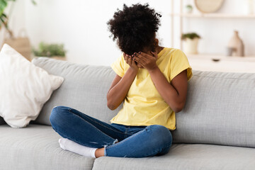 Depressed African Girl Crying Covering Face Feeling Sad Sitting Indoor