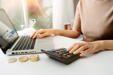 Healthcare costs and fees concept.Hand of smart doctor used a calculator for medical costs in modern hospital