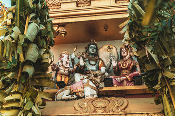 Hindu temple full of colorful ornaments against a blue sky on a sunny day.  © insomniafoto