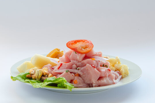 Traditional seafood ceviche from Peru with chili peppers, chickpeas. White background.