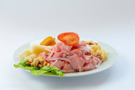 Traditional seafood ceviche from Peru with chili peppers, chickpeas. White background.