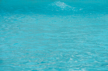 Fototapeta na wymiar Closeup water surface in swimming pool. Selective shallow dept of field.