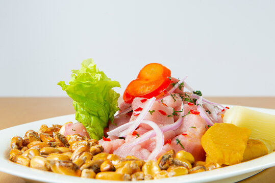 Delicious seafood ceviche from Peru with chili peppers, chickpeas. White background.