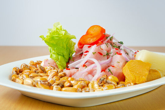 Delicious seafood ceviche from Peru with chili peppers, chickpeas. White background.