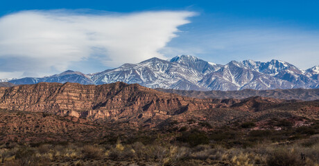 Mountains of the Potrerillos covered by snow in the field.