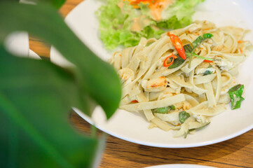 Pasta fettuccine alfredo with chicken, thai curry cuisine.