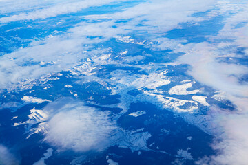 Over the Snowy Mountains . Aerial view of Alps in the winter 