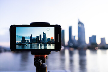 A phone on tripod recording the beautiful landscape sunset of Ho Chi Minh city or Sai Gon, Vietnam...