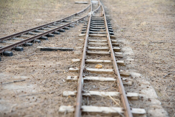 Fototapeta premium Small abandoned train tracks are a game for children.