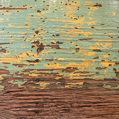 weathered light green and yellow painted wood top view closeup, rough ckground