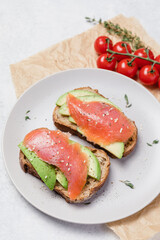 Open sandwich with avocado, smoked salmon and rye bread.