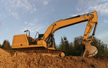 Excavator digging in ground on construction site