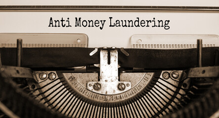 Words 'Anti Money Laundering' typed on retro typewriter. Business concept.
