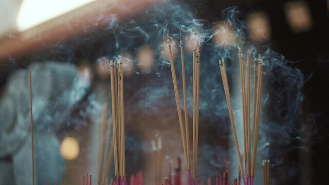 Buddhist altar with smoldering joss sticks