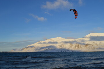 Kite surfing in the ice fjord outside of Longyearbyen in Svalbard (Spitsbergen), Norway