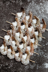 Fresh shrimps on skewers. Vertical photo.