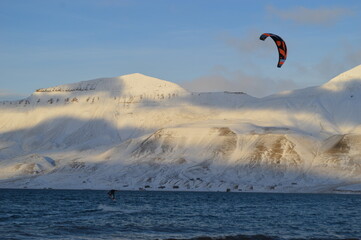 Kite surfing in the ice fjord outside of Longyearbyen in Svalbard (Spitsbergen), Norway