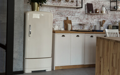 Antique retro fridge in kitchen with brick wall