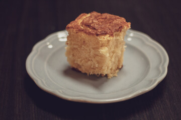 Square slice of lemon yogurt cake on light blue plate