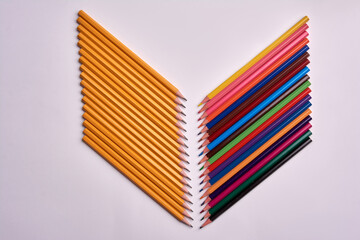 colored pencils and gray pencils on a white background