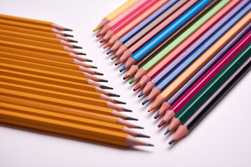 colored pencils and gray pencils on a white background