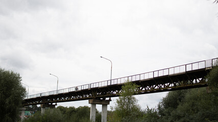 pedestrian bridge against a cloudy sky. mid-autumn