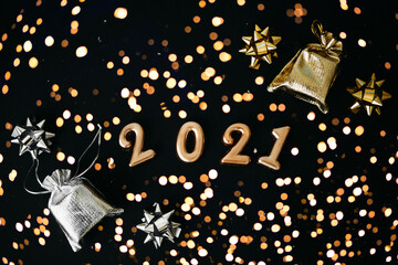 Gold numbers 2021 on a festive black background. Christmas or New Year conceptual background.