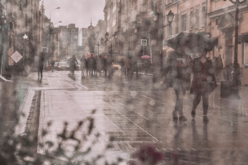 Abstract blurred background of walking people under umbrellas, street in rainy in the afternoon, silver shiny bokeh of the city. View through a wet window with raindrops