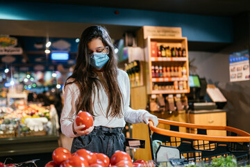 The girl with surgical mask is going to buy tomatos.