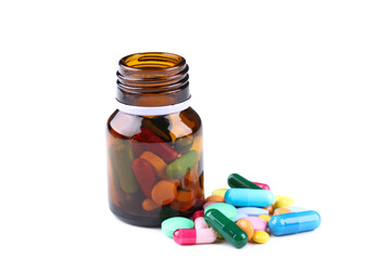 Colorful pills and bottle on white background