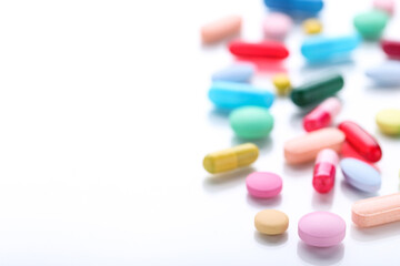 Colorful pills on white background