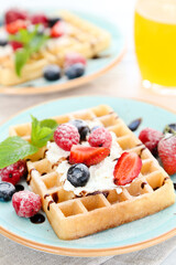 Tasty waffles with fresh berries and whipped cream