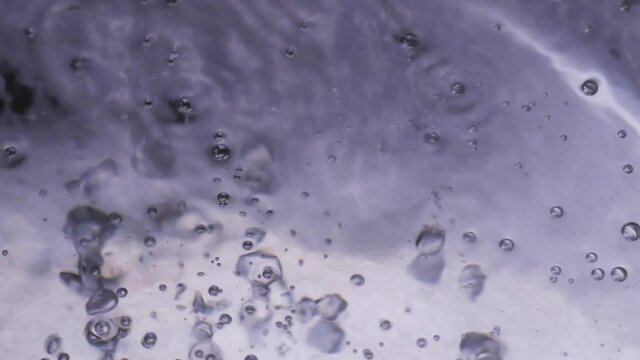 Slow motion boiling water, static extreme close up.