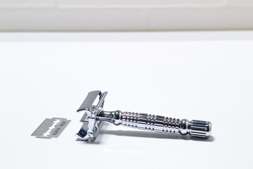 Traditional razor on white background in bathroom