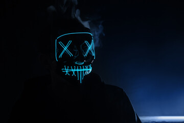 Portrait of an anonymous hacker in a neon mask, Halloween mask