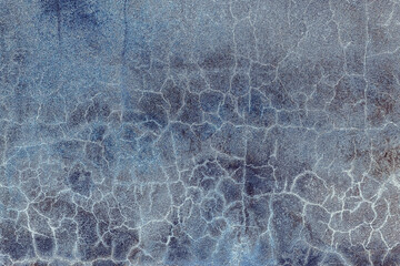 Abstract blue background. Cracks. The texture of the old surface. Cracks in the old plaster. Old texture. Grunge texture. Blue grunge background.