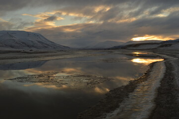 Sunset reflections over the frozen Arctic Norwegian Archepelago of Svalbard, Norway