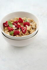 Oatmeal with raspberries, honey and almond petals. Healthy breakfast.