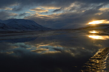 Sunset reflections over the frozen Arctic Norwegian Archepelago of Svalbard, Norway